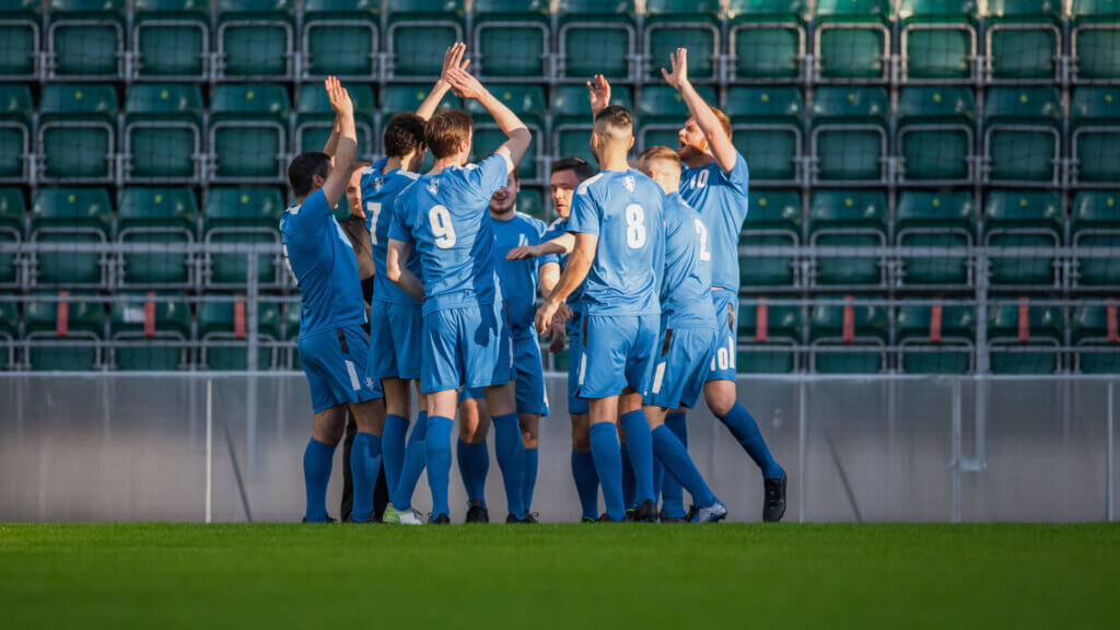 A team of soccer players celebrating after a successful practice session